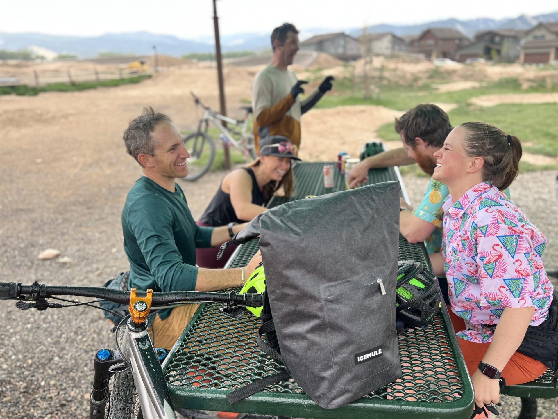 Group of mountain bikers taking a break with the Jaunt ICEMULE sitting on a picnic table.